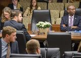 A photo of the committee member table. Flowers were placed on the table in front of an empty seat.